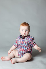 Fototapeta premium laughing baby in plaid shirt and bow tie