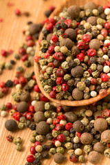 Peppercorn mix in a wooden spoon