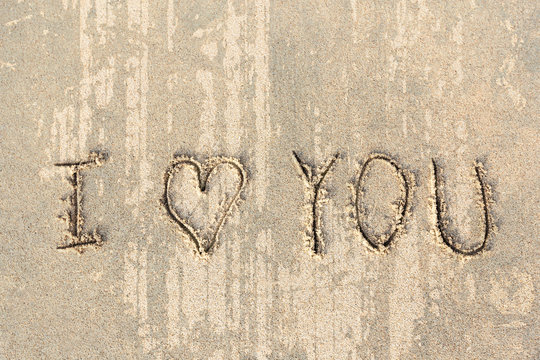 I love you handwritten in sand for natural