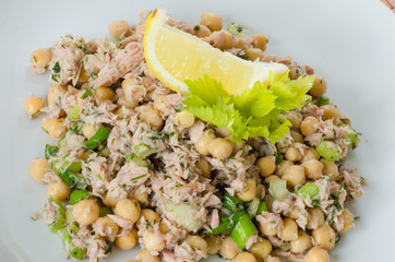 Close up on a dish of chickpea salad with tuna and herbs