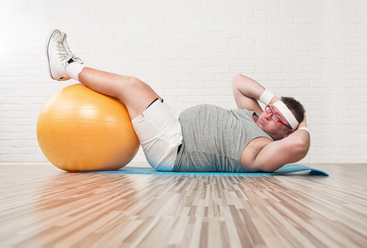 Funny Overweight Man Working Out In The Gym