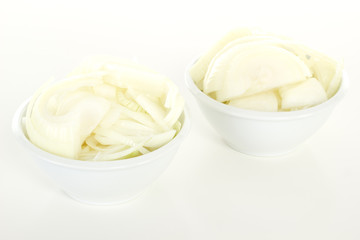 Cutted onions in white bowls