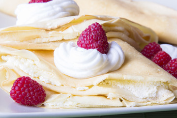 pancakes with whipped cream and raspberries