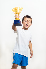 Little boy celebrates his golden trophy