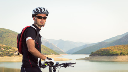 Mountain biker beside a beautiful lake
