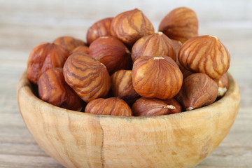 Hazelnuts in wooden bowl, close up