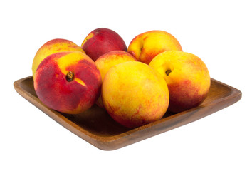 Nectarines in wooden plate
