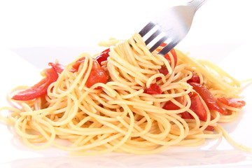 Pasta with tomatoes and garlic being eaten with a fork