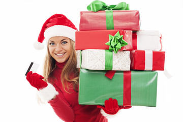 Beautiful woman holding christmas presents and credit card