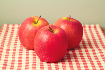 Fresh apples on red chcked tablecloth