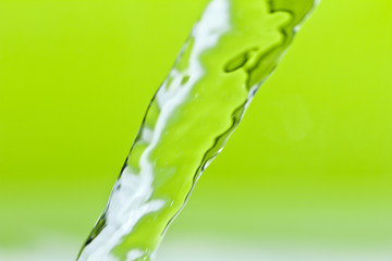 a jet of water on a green background