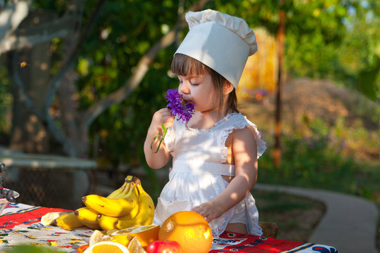 Little girl chef and flower