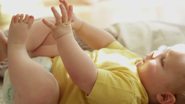 Happy Baby Playing With His Feet