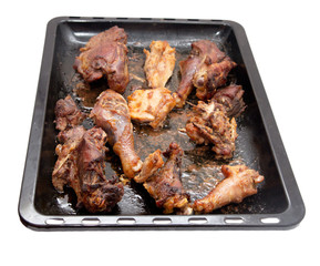 roasted chicken on a baking sheet on a white background