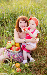happy mother and child with fruits outdoor
