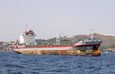 Rusty cargo ship at sea