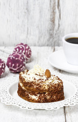 Tiramisu cake on white plate. Wooden background, selective focus