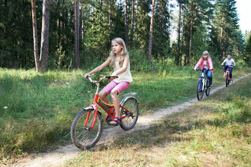 Children riding bikes in woods