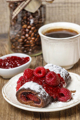 Swiss roll (roulade) with raspberries on white plate. Selective