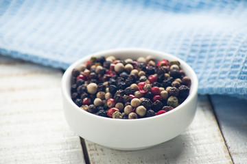 Mixed pepper on wooden background