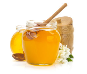 glass jar full of honey and stick