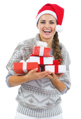 Happy woman in sweater and christmas hat with present box