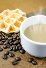 Coffee cup with grains and waffle