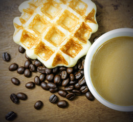 Coffee cup with grains and waffle