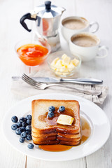 French toast with blueberries, maple syrup and butter