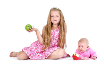 Fototapeta premium adorable little two sisters 8 year and 3 month ols with apple