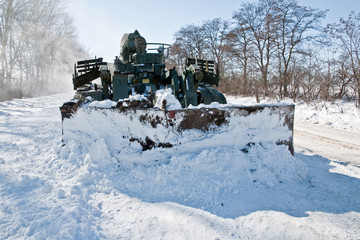 tank cleans the road from snow