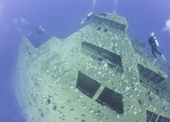 Scuba divers exploring a shipwreck