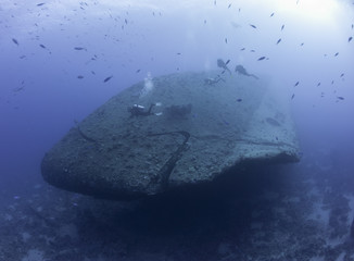 Scuba divers exploring a shipwreck