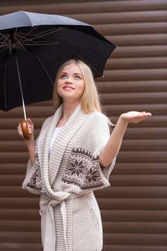Girl with umbrella. Beautiful young blond hair woman holding umb