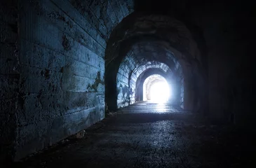 Foto op Plexiglas Tunnel Blauwe gloeiende uitgang van donkere verlaten tunnel