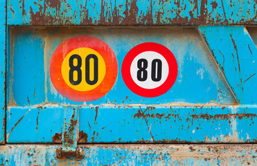 Speed limit signs on the back of old blue truck