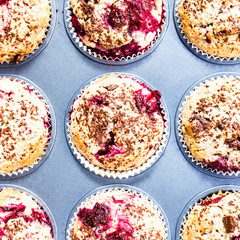 Homemade chocolate muffins with cherry  in baking tin  top view.