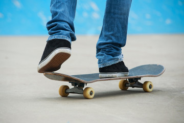 Skateboarder riding skateboard at skate park.