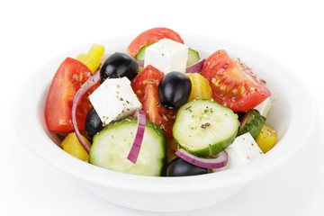 fresh greek salad in white bowl