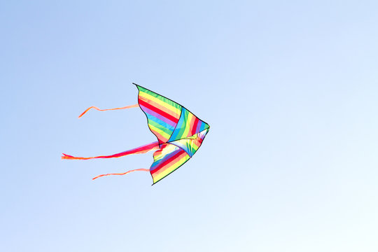 colorful kite flying on background of blue sky