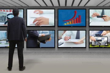 Fototapeta premium Businessman looking at the TV screen