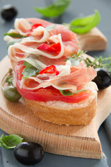 Bruschetta with prosciutto, tomato and basil.