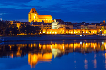 Torun old town at night reflected in the river, Poland © Patryk Kosmider