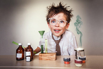 Crazy scientist. Young boy performing experiments - obrazy, fototapety, plakaty