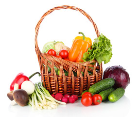 Fresh vegetables in wicker basket  isolated on white