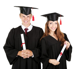 Two happy graduating students isolated on white