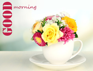 Beautiful bouquet of bright flowers in color mug,