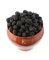 blackberries in a clay jug