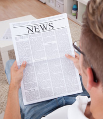 Young Man Reading Newspaper