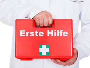 Male doctor carrying a portable first aid kit